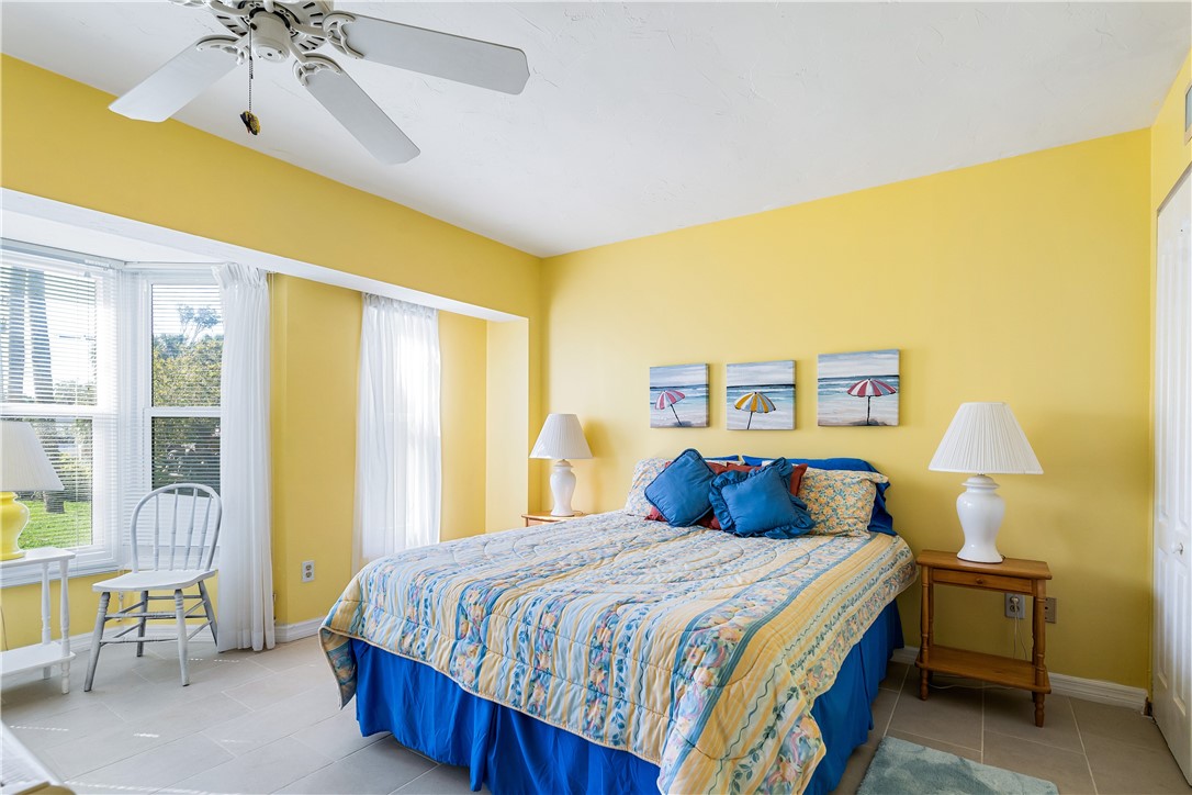 635 Live Oak Road Vero Beach, FL 32963 - Photo 21 of 35 a bedroom with a bed and a chandelier