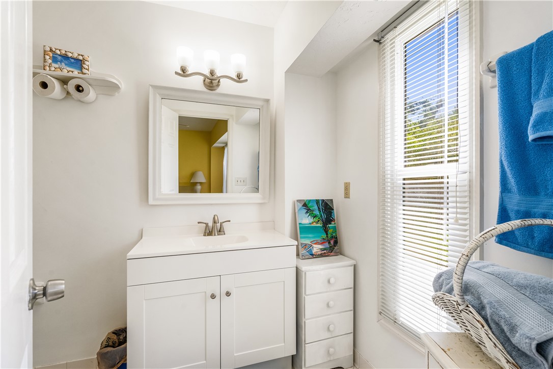 635 Live Oak Road Vero Beach, FL 32963 - Photo 22 of 35 a bathroom with a sink and a mirror