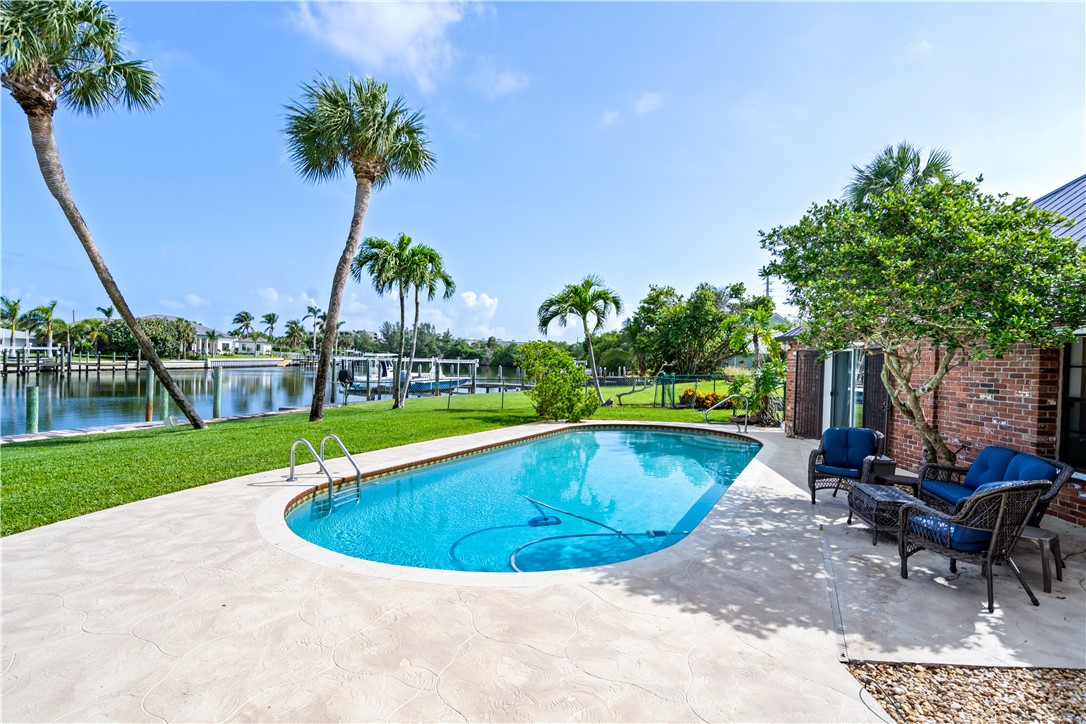 635 Live Oak Road Vero Beach, FL 32963 - Photo 26 of 35 a view of a swimming pool and lounge chairs
