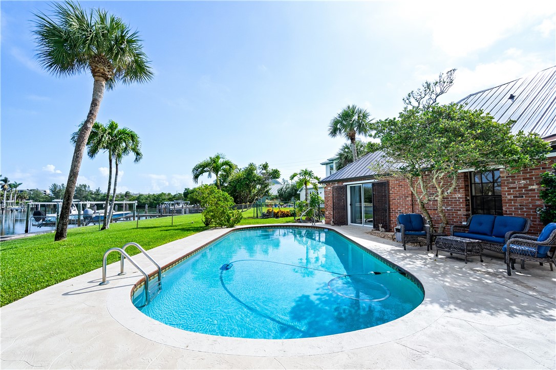 635 Live Oak Road Vero Beach, FL 32963 - Photo 27 of 35 a view of a house with swimming pool and sitting area