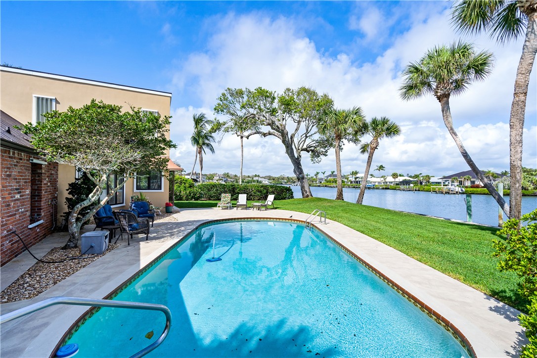 635 Live Oak Road Vero Beach, FL 32963 - Photo 30 of 35 a view of swimming pool with a table and chairs