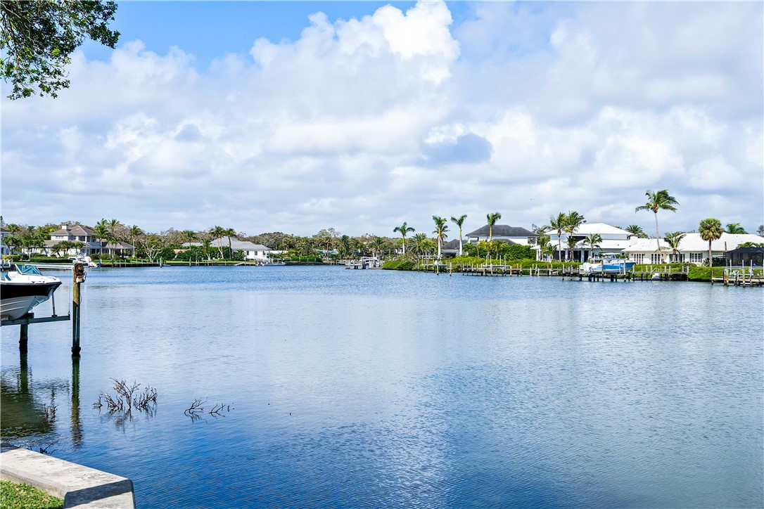 635 Live Oak Road Vero Beach, FL 32963 - Photo 33 of 35 a view of a lake with houses in the back
