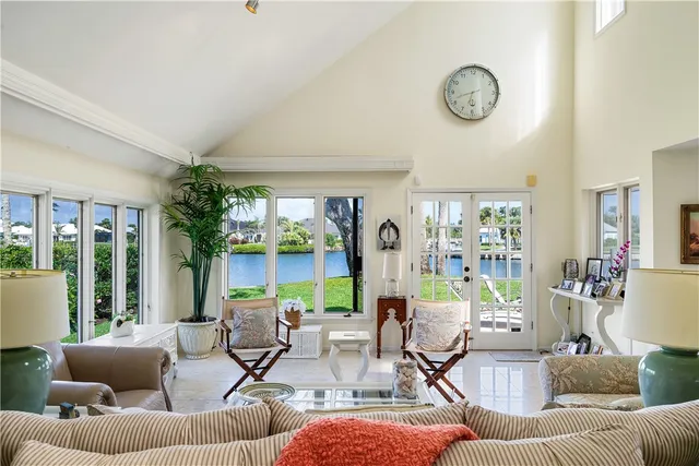 a living room with fireplace furniture and a large window