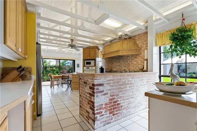 a kitchen with table chairs sink and cabinets