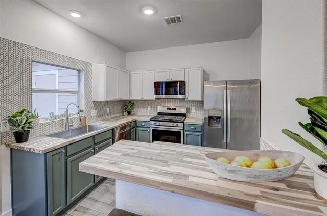 a kitchen with a refrigerator and a sink