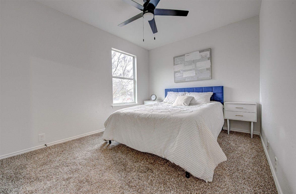 6249 Negley, Unit B Kyle, TX 78640 - Photo 14 of 26 Carpeted bedroom featuring ceiling fan and baseboards