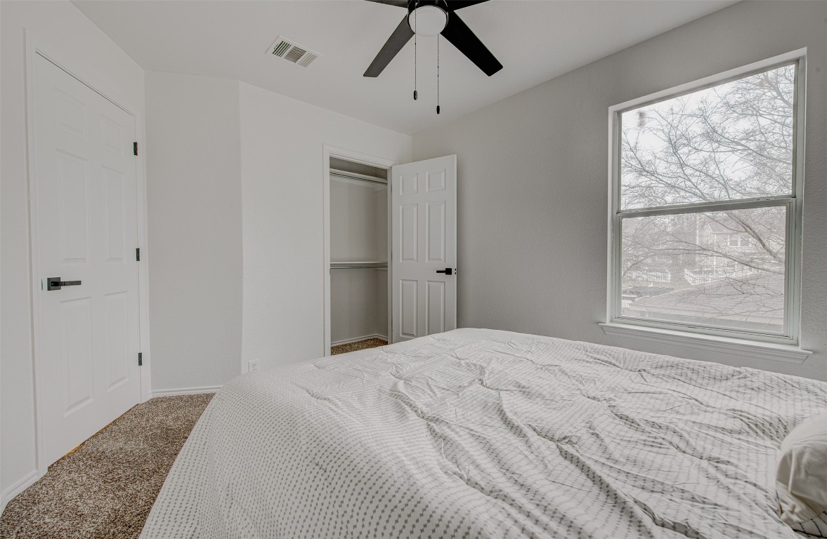 6249 Negley, Unit B Kyle, TX 78640 - Photo 15 of 26 Carpeted bedroom featuring a ceiling fan and a closet