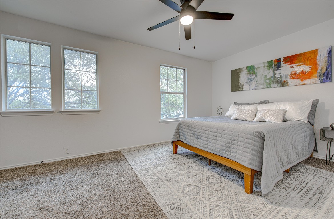 6249 Negley, Unit B Kyle, TX 78640 - Photo 19 of 26 Bedroom with light carpet and a ceiling fan