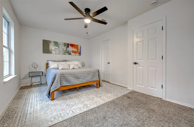 a bedroom with furniture and window