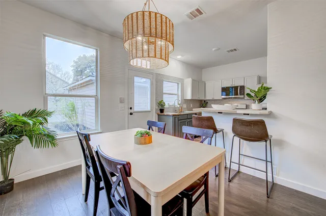 a view of a dining room with furniture and a chandelier