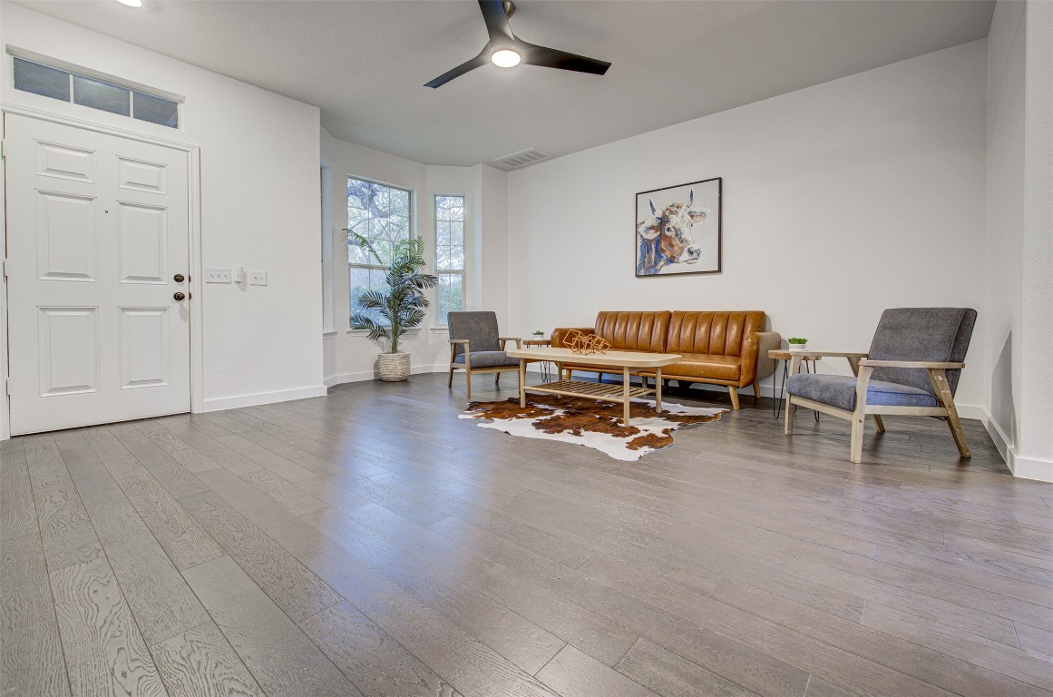 6249 Negley, Unit B Kyle, TX 78640 - Photo 7 of 26 Living area featuring wood-type flooring and ceiling fan