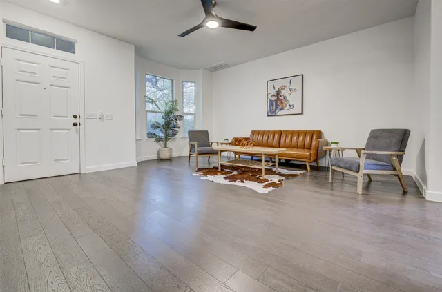 a view of a livingroom with furniture and a window