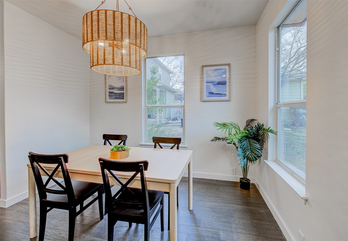 6249 Negley, Unit B Kyle, TX 78640 - Photo 10 of 26 Dining area featuring dark wood-style flooring and a chandelier
