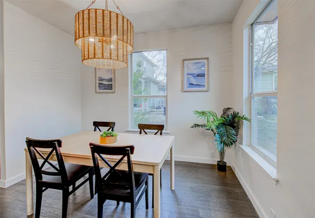 a view of a dining room with furniture and wooden floor