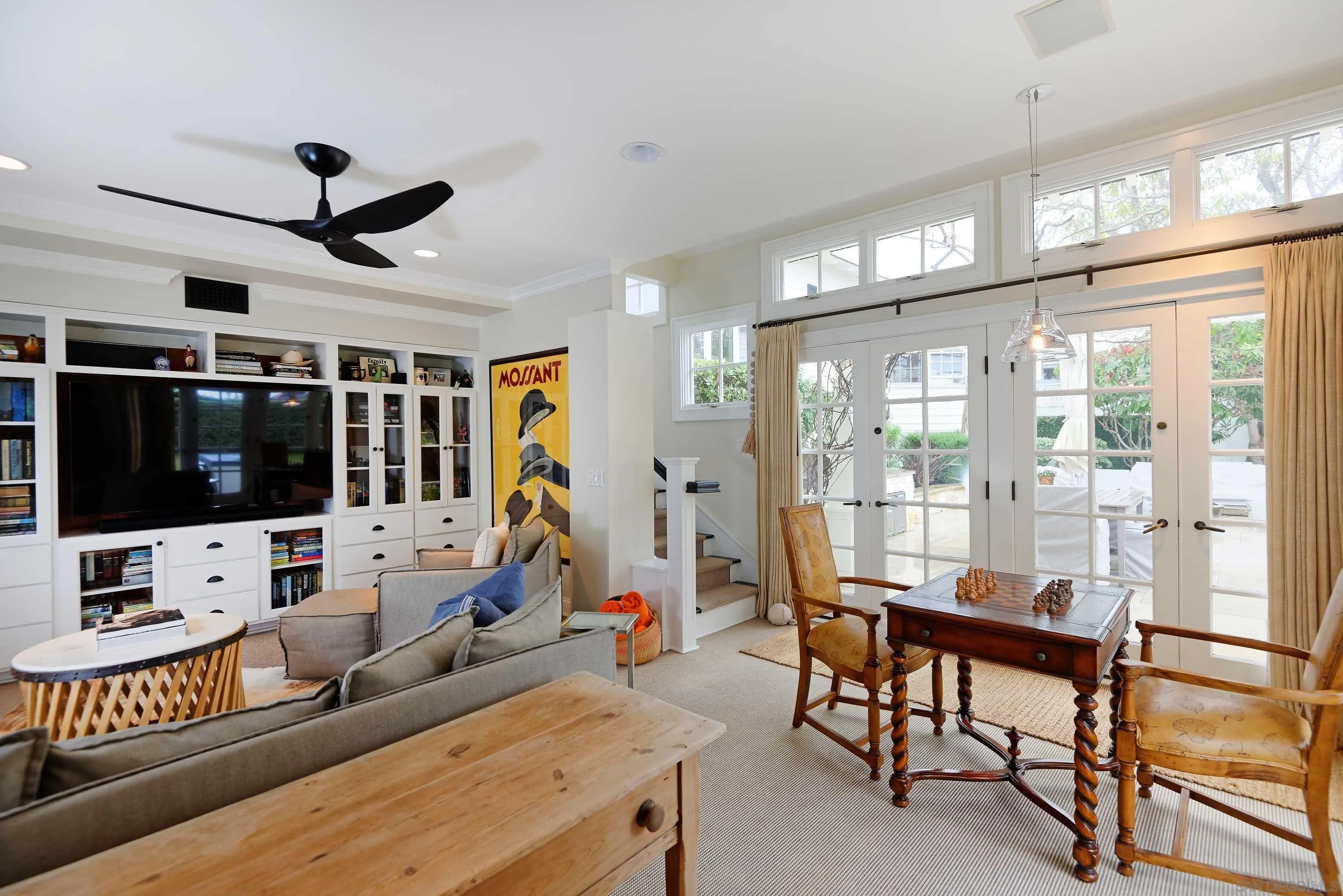 5844 Beaumont Avenue La Jolla, CA 92037 - Photo 17 of 26 a living room with furniture a flat screen tv and a large window