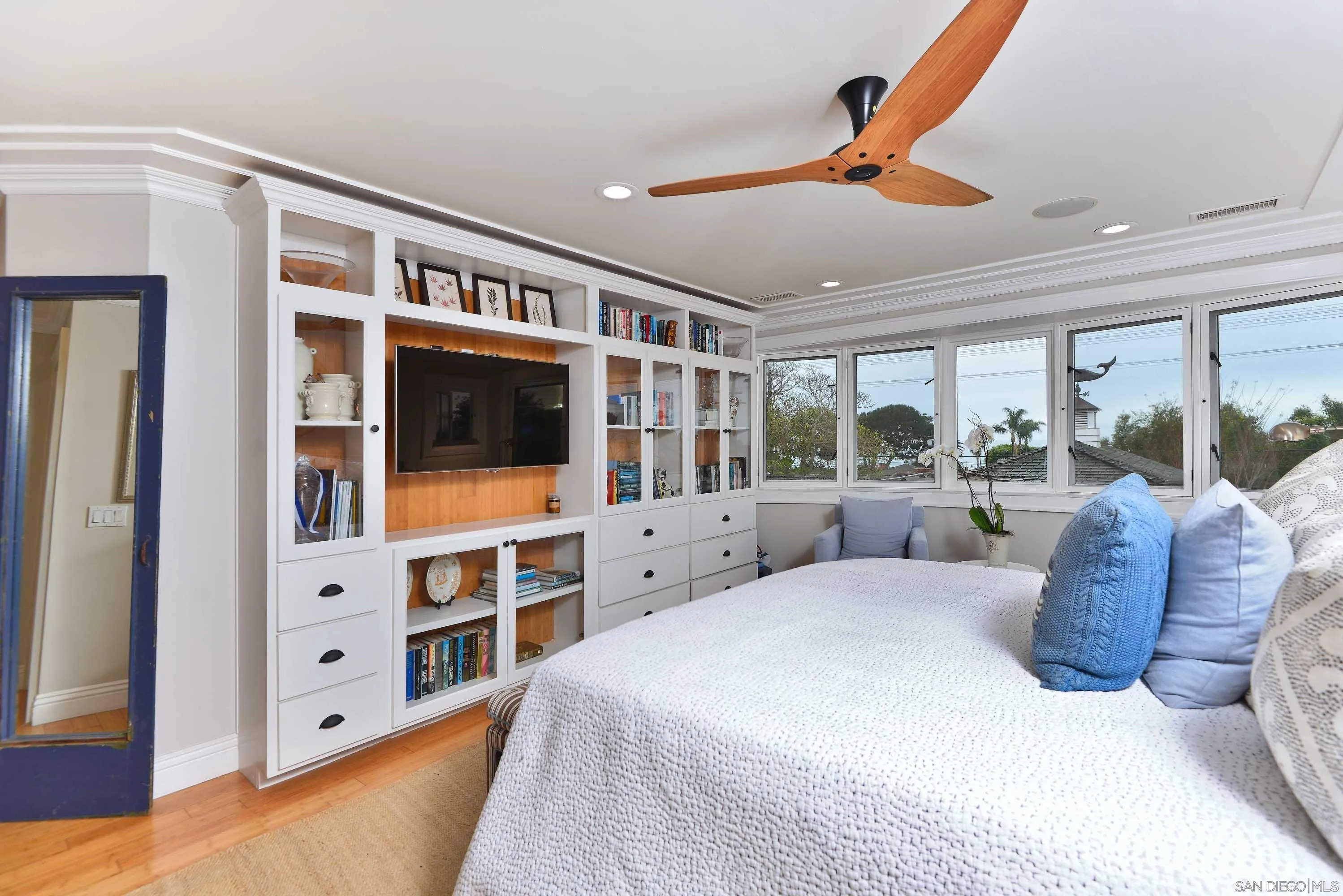 5844 Beaumont Avenue La Jolla, CA 92037 - Photo 18 of 26 a large bedroom with a large bed and a flat tv screen