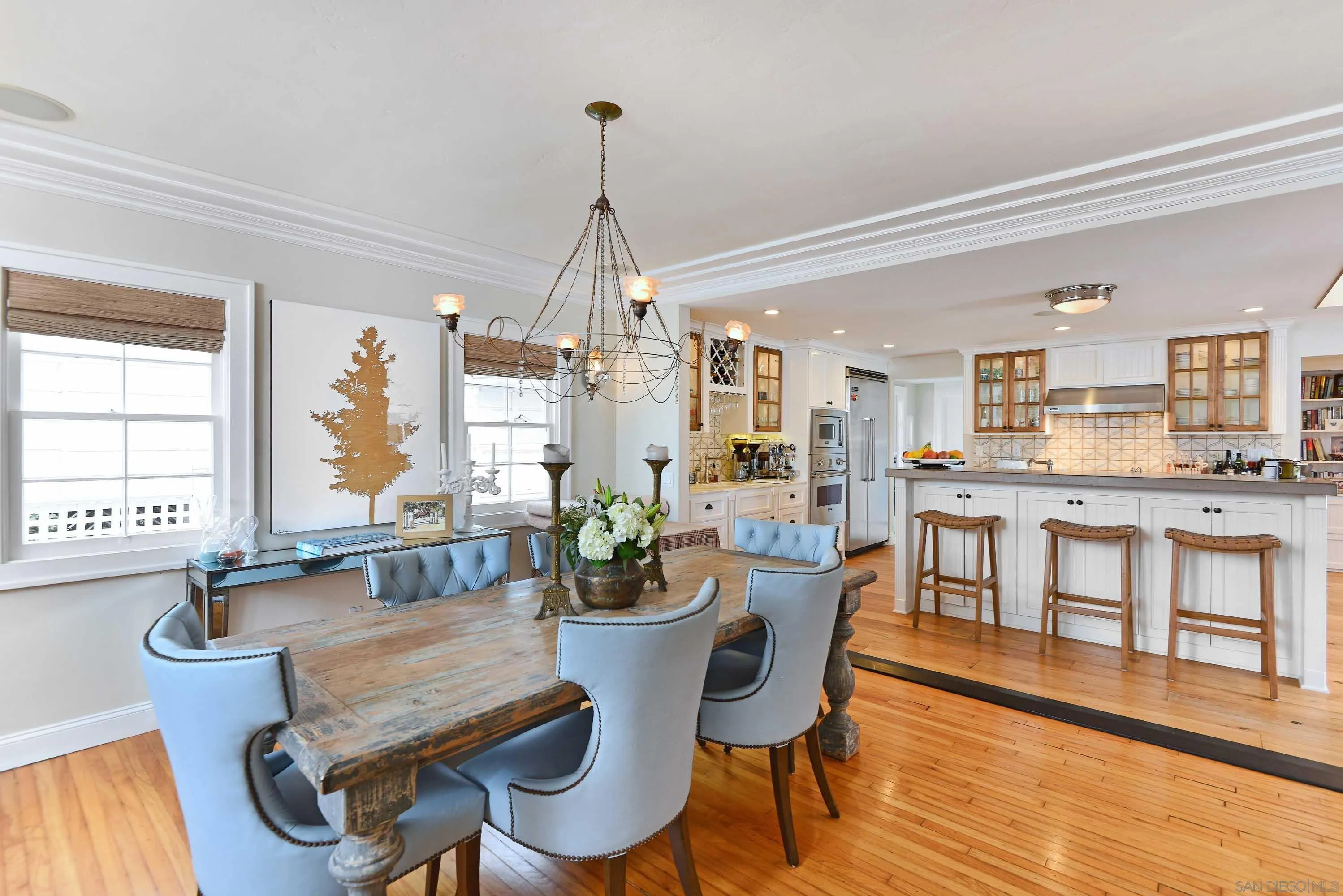 5844 Beaumont Avenue La Jolla, CA 92037 - Photo 6 of 26 a dining room with furniture a chandelier and wooden floor