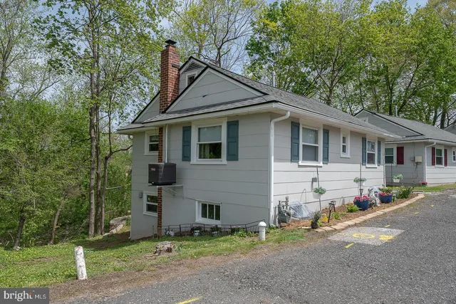 a bedroom with a bed and a potted plant