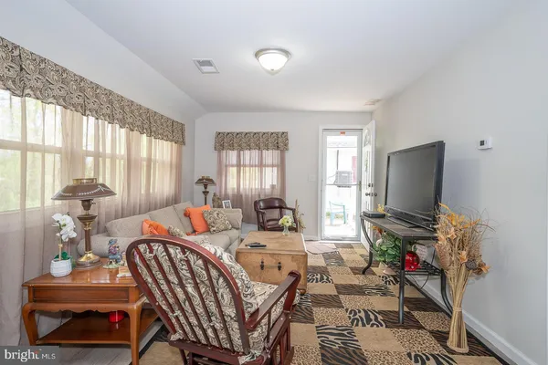 a living room with furniture and a rug