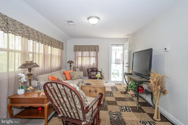 a view of backyard with table and chairs a barbeque and a large trees