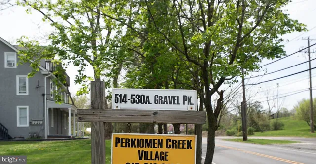 a view of a house with backyard and a tree