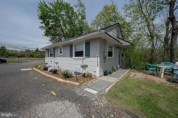 a view of a house with a yard and tree s