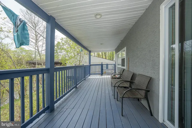 a wooden bench sitting in the middle of a yard