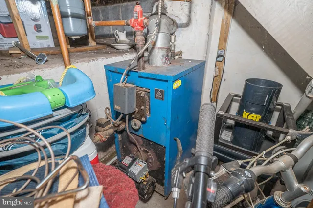 a roof deck with table and chairs under an umbrella