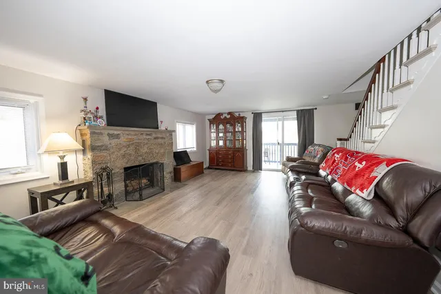 a view of a patio with table and chairs potted plants and a large tree