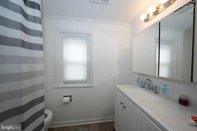 an aerial view of a house with a yard and lake view