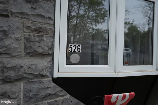 an aerial view of a house with outdoor space and sitting area