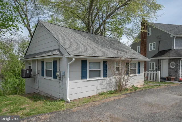 an aerial view of residential house with outdoor space and trees around
