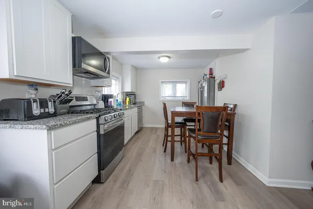 a view of a house with a big yard and large trees