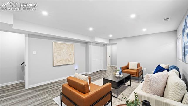 562 Blossom Field Road Fountain, CO 80817 - Photo 26 of 41 Living area featuring wood finished floors and recessed lighting