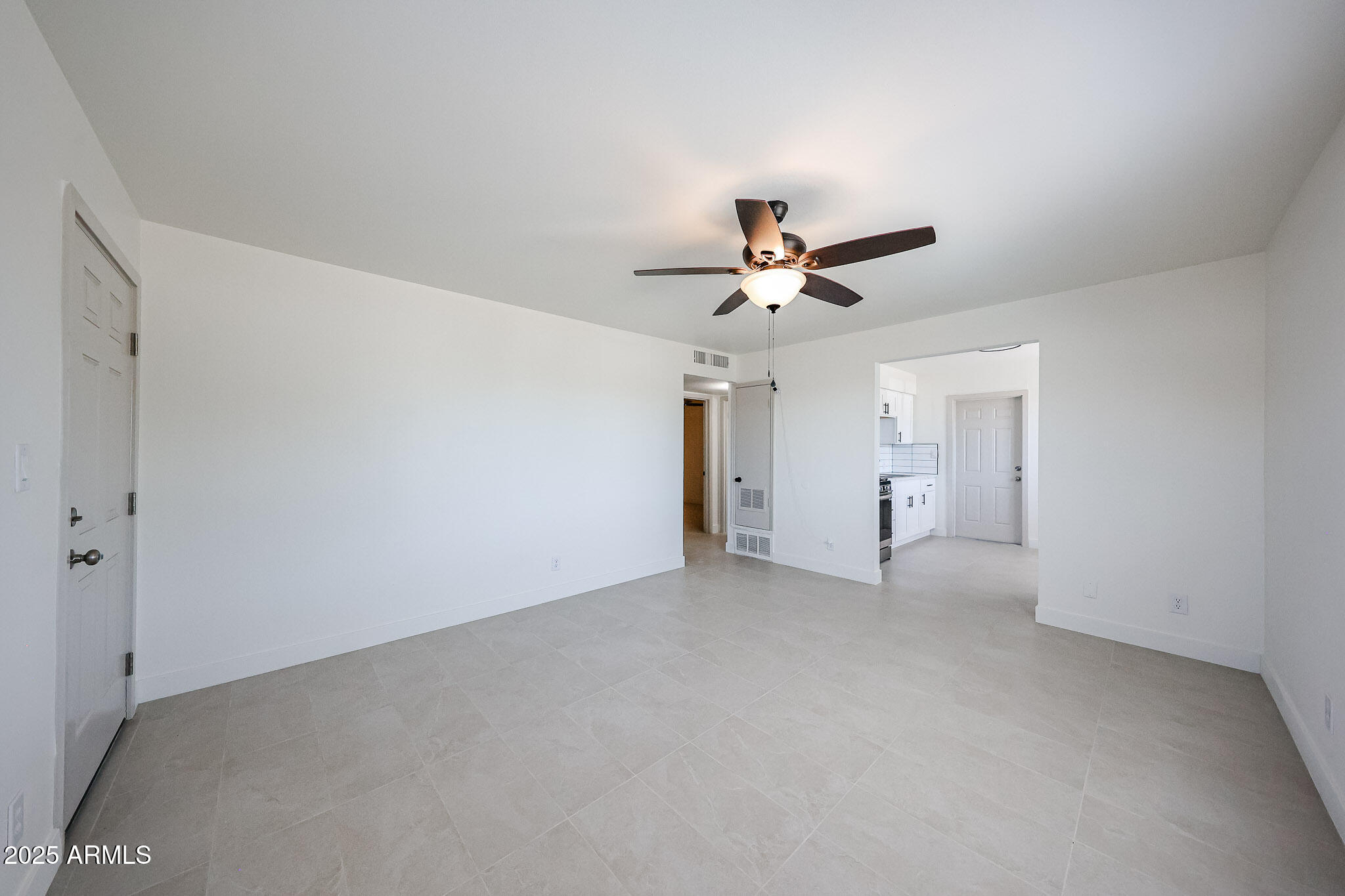 10202 North 15th Avenue, Unit 2 Phoenix, AZ 85021 - Photo 11 of 34 a view of a livingroom with a ceiling fan and wooden floor