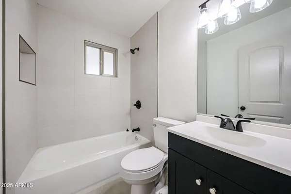 a kitchen with stainless steel appliances granite countertop a sink and a refrigerator