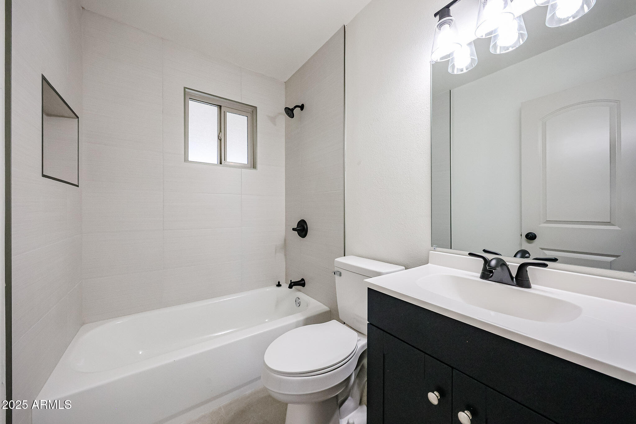 10202 North 15th Avenue, Unit 2 Phoenix, AZ 85021 - Photo 16 of 34 a bathroom with a sink a toilet and a bathtub
