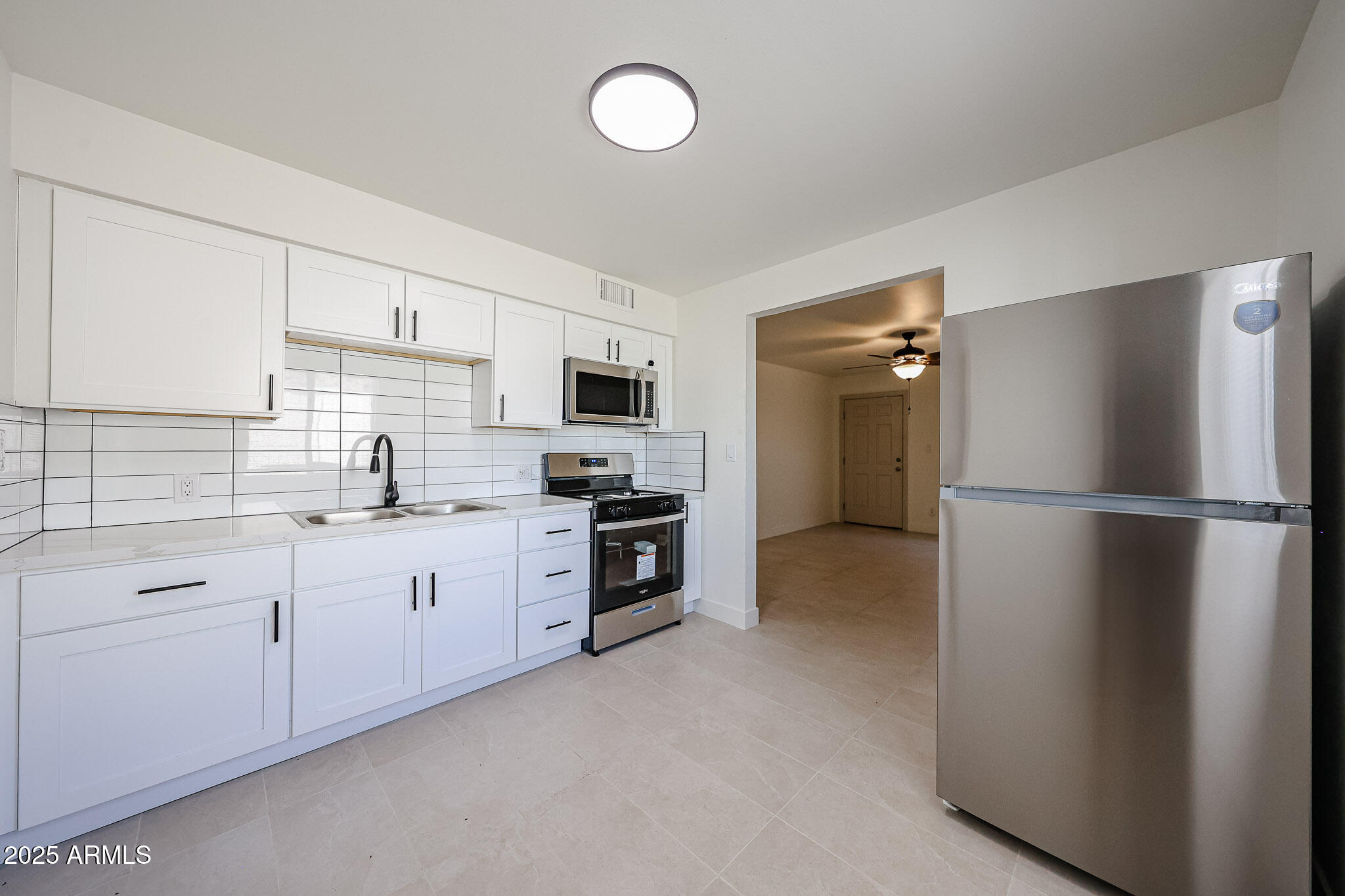 10202 North 15th Avenue, Unit 2 Phoenix, AZ 85021 - Photo 18 of 34 a kitchen with refrigerator a sink and cabinets