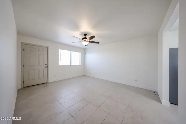 a view of a livingroom with a chandelier fan