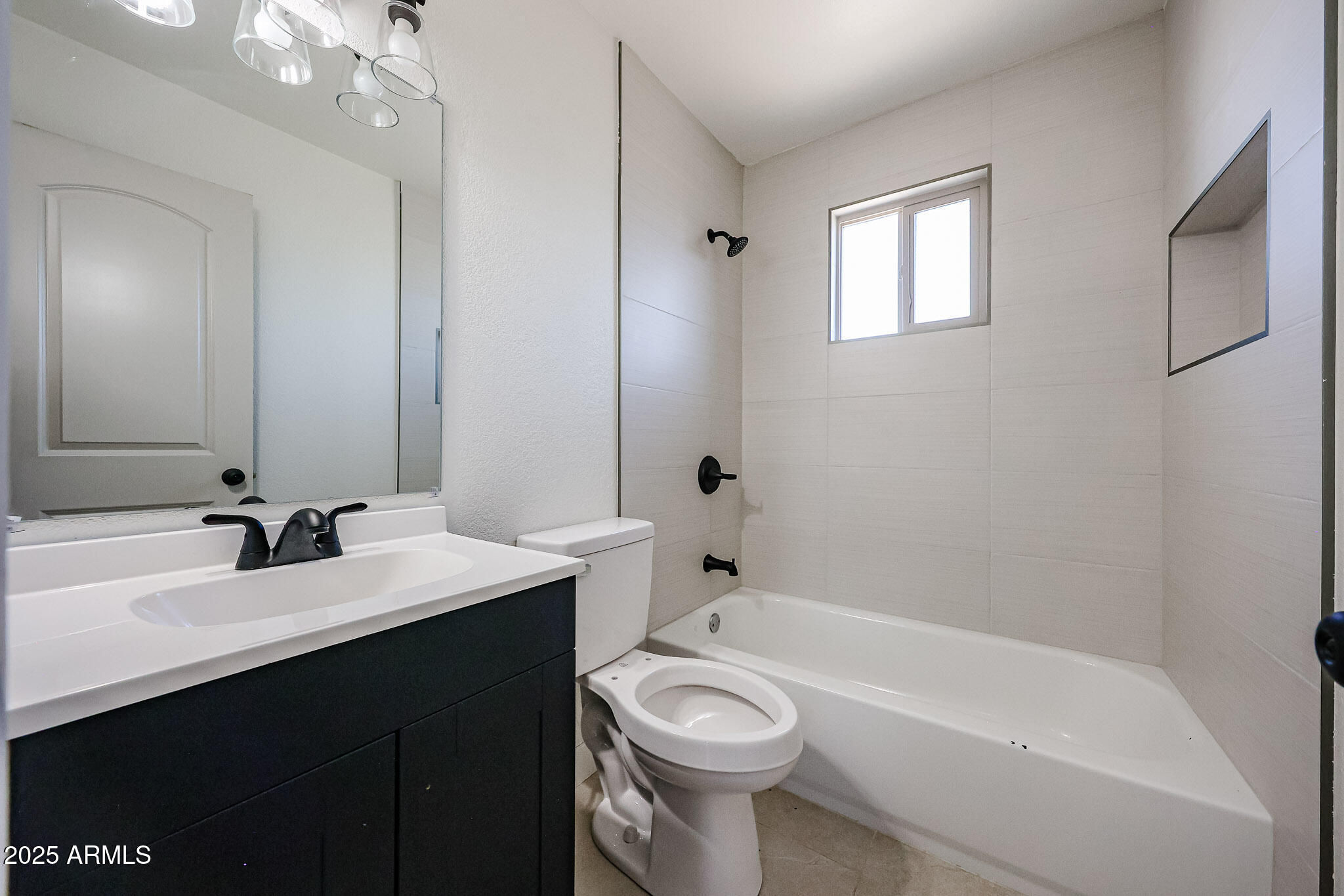 10202 North 15th Avenue, Unit 2 Phoenix, AZ 85021 - Photo 25 of 34 a bathroom with a sink a toilet and shower