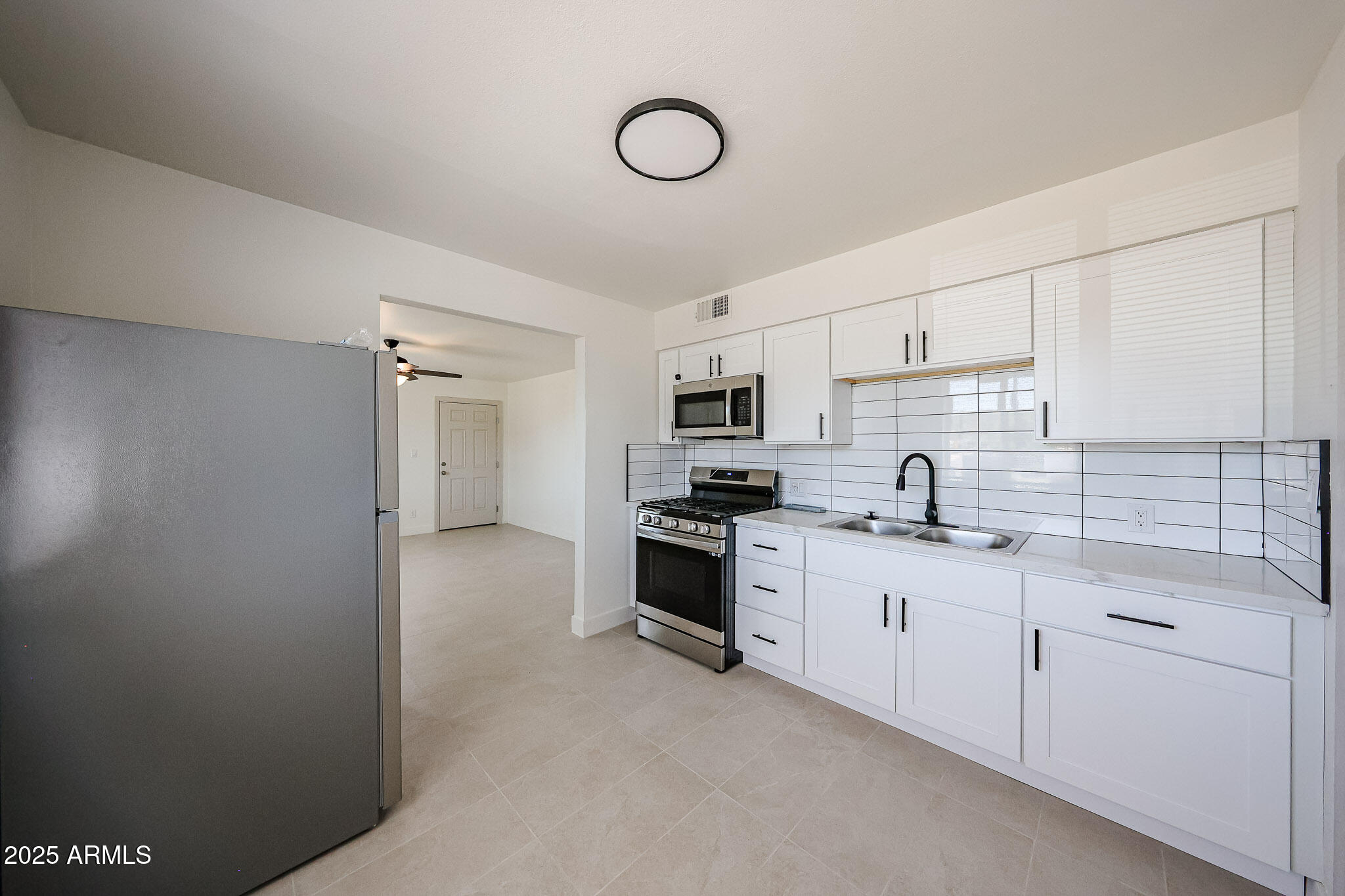 10202 North 15th Avenue, Unit 2 Phoenix, AZ 85021 - Photo 7 of 34 a kitchen with appliances cabinets and a sink