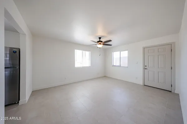 a view of a livingroom with a ceiling fan and wooden floor
