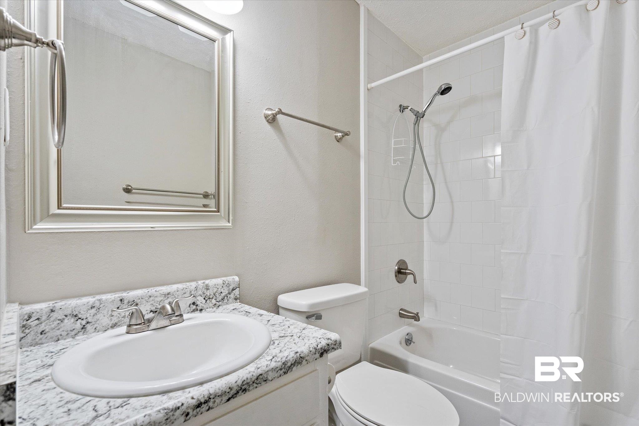 4017 Cottage Hill Road, Unit 59 Mobile, AL 36609 - Photo 18 of 25 Full bathroom with toilet, shower / tub combo with curtain, and vanity