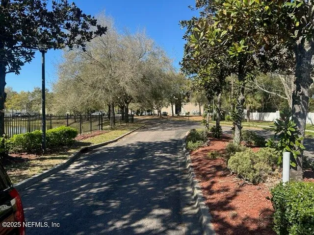 a view of yard with swimming pool and green space