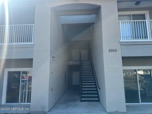 a view of a hallway with entryway door
