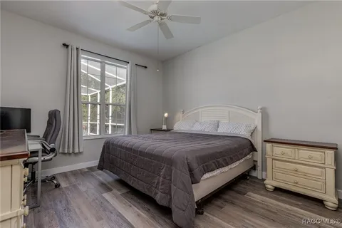 a bedroom with a bed a desk and chair