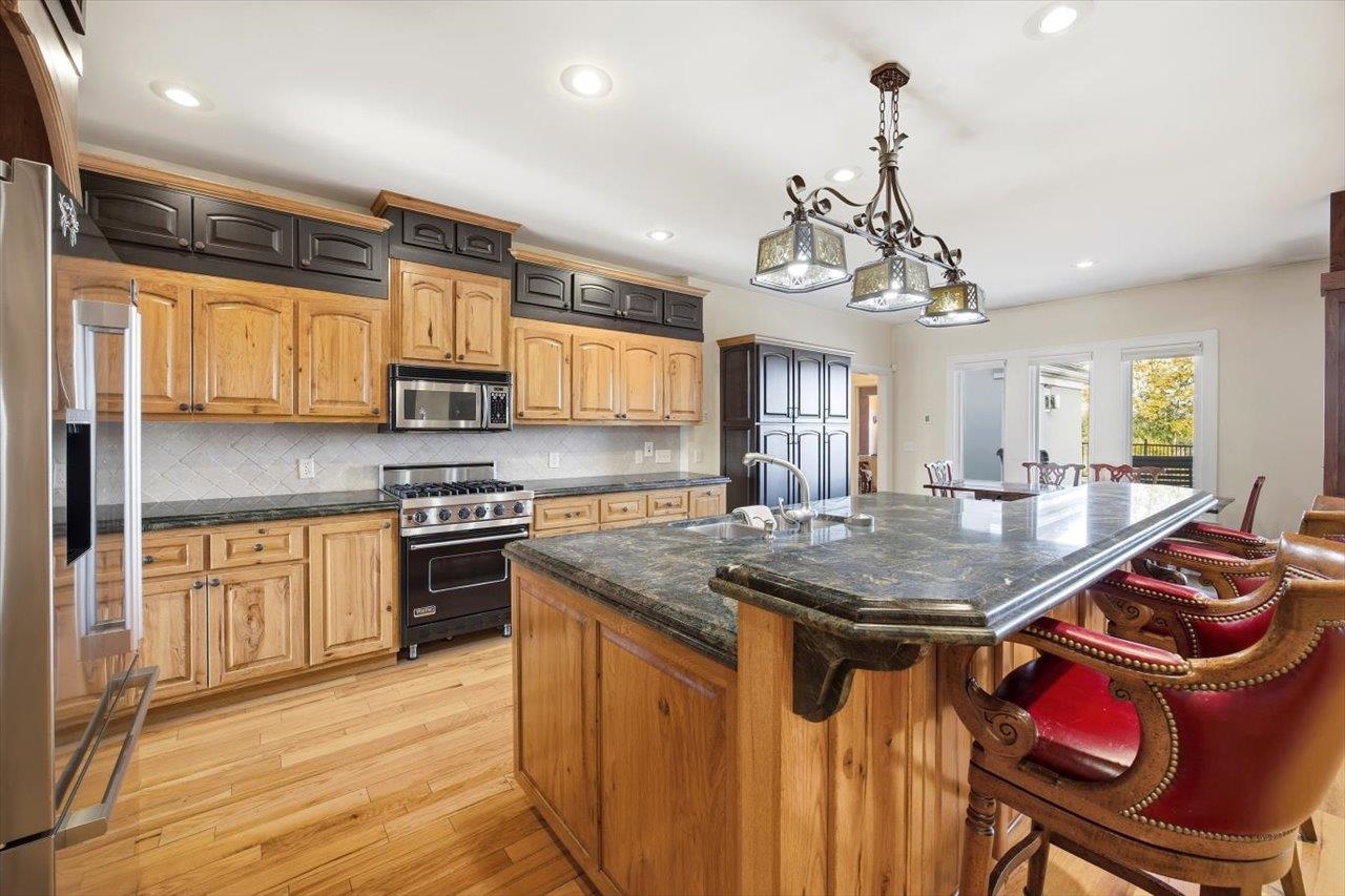 2223 Airport Road Bridgewater, VA 22812 - Photo 10 of 74 a kitchen with stainless steel appliances granite countertop a sink a stove a refrigerator cabinets and living room view