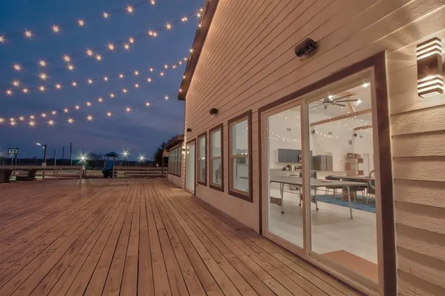 a view of a porch with wooden floor and fence