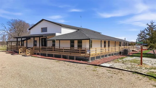 a front view of a house with a yard table and chairs