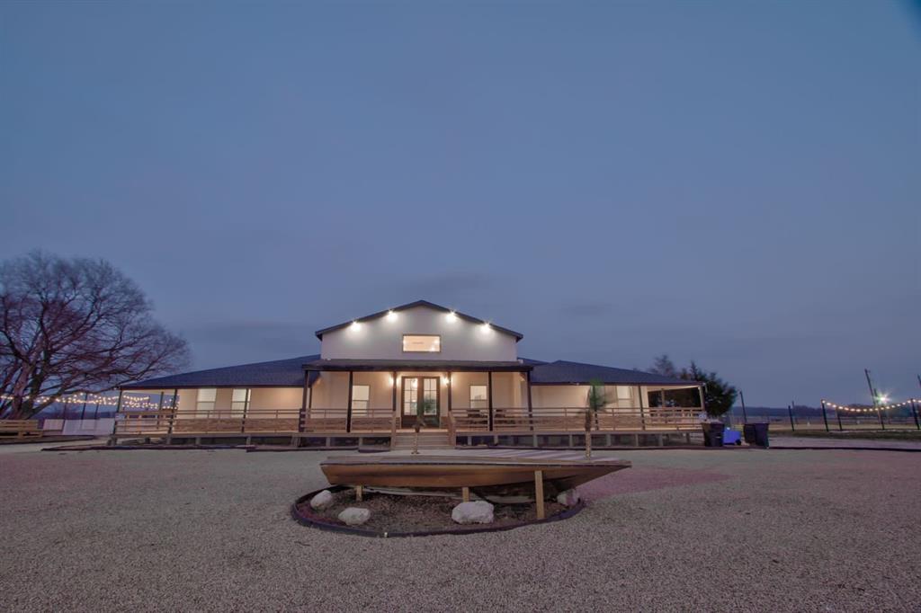 550 County Road 297 Gainesville, TX 76240 - Photo 21 of 24 a roof deck with a table and chairs under an umbrella
